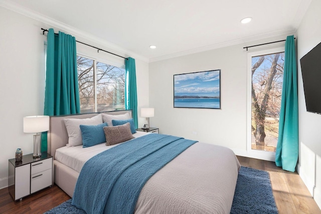 bedroom featuring multiple windows, ornamental molding, and dark hardwood / wood-style floors