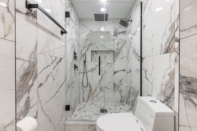 bathroom featuring walk in shower, toilet, and tile walls