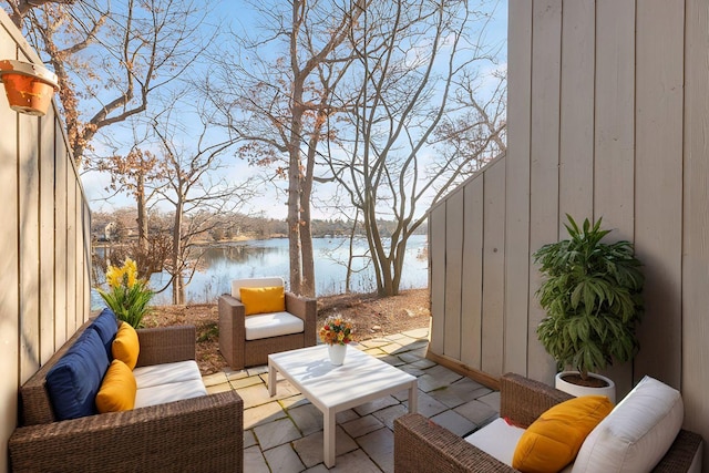 view of patio with a water view and an outdoor hangout area