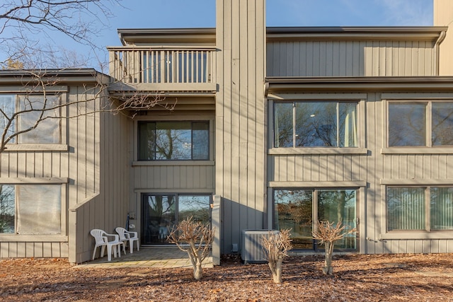 back of house with a balcony, a patio, and central air condition unit