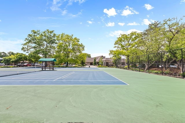 view of sport court featuring fence