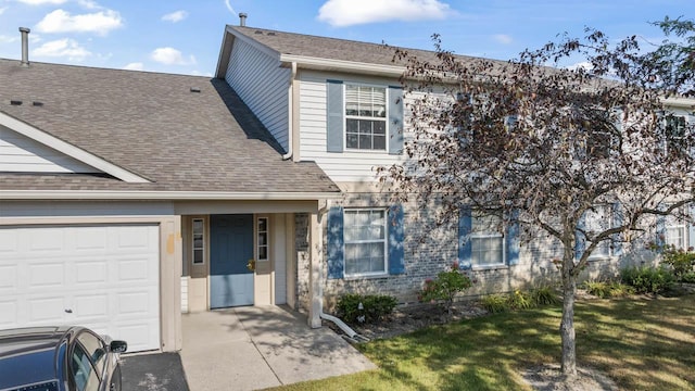 view of front of property with a garage and a front yard