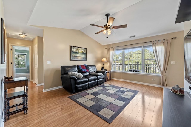 living room with light hardwood / wood-style flooring, ceiling fan, and lofted ceiling