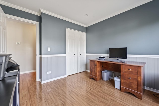 office space featuring light wood-type flooring and crown molding