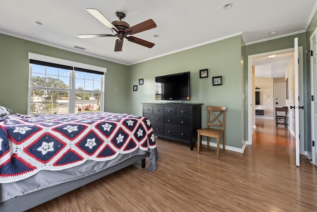 bedroom featuring hardwood / wood-style floors, ceiling fan, and crown molding