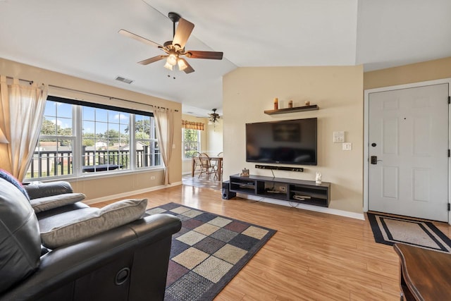 living room with wood-type flooring, ceiling fan, and lofted ceiling