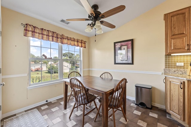 dining room with ceiling fan and vaulted ceiling