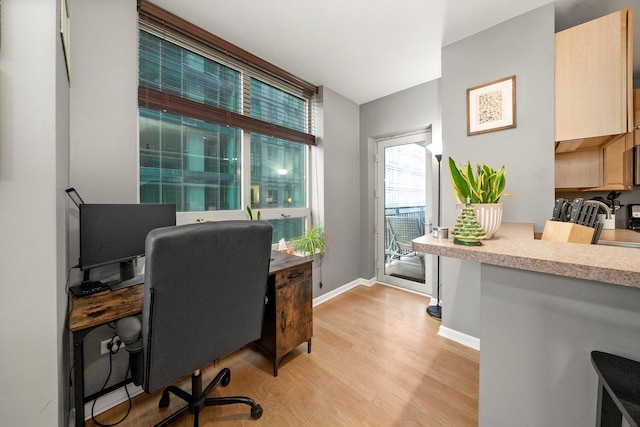 office area with light hardwood / wood-style flooring