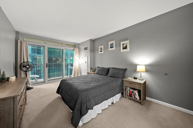 bedroom featuring access to exterior, light carpet, and floor to ceiling windows