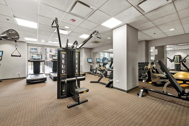 exercise room featuring plenty of natural light, carpet floors, and a drop ceiling