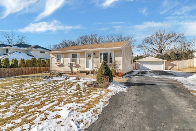 view of front of property with an outbuilding, fence, and a detached garage