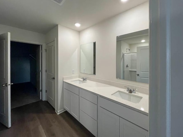 bathroom featuring vanity, hardwood / wood-style floors, and a shower