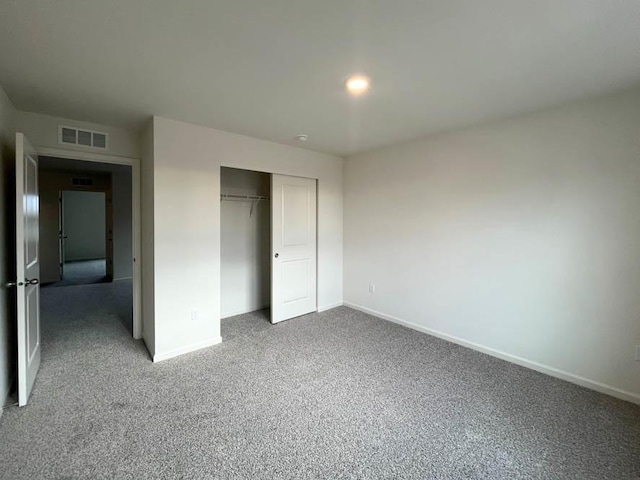 unfurnished bedroom featuring a closet and carpet