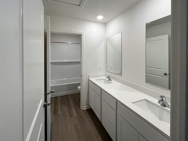 full bathroom featuring vanity, wood-type flooring, shower / tub combination, and toilet