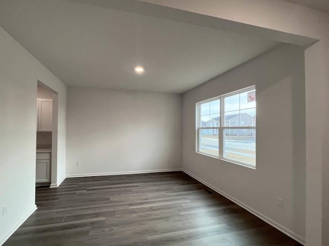 empty room featuring dark hardwood / wood-style flooring