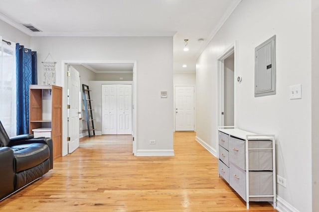 interior space featuring electric panel, light hardwood / wood-style floors, and crown molding