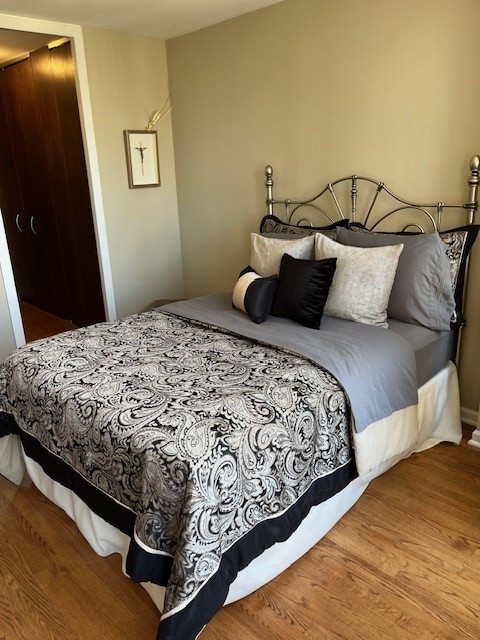 bedroom with hardwood / wood-style flooring