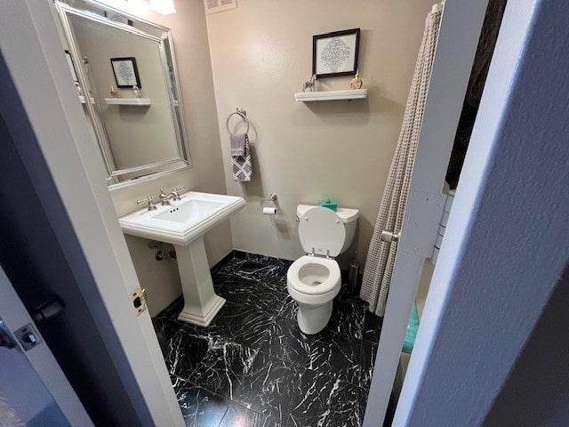 bathroom with toilet and sink