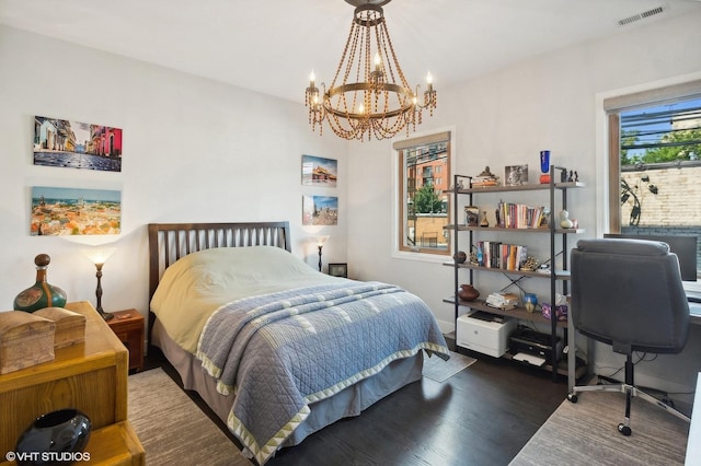 bedroom featuring dark wood-type flooring and a chandelier