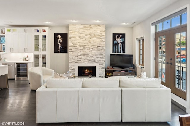 living room with french doors, indoor bar, wine cooler, and dark wood-type flooring