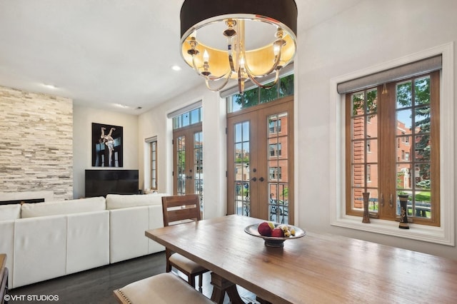 dining area with french doors and a notable chandelier