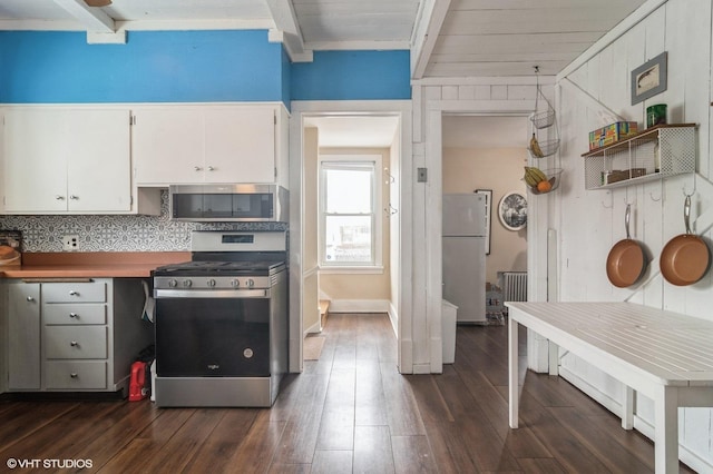 kitchen featuring backsplash, white cabinetry, beamed ceiling, and appliances with stainless steel finishes