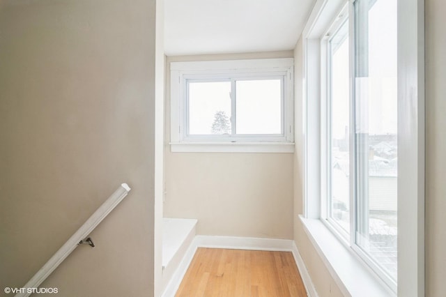 stairway with hardwood / wood-style floors and a wealth of natural light