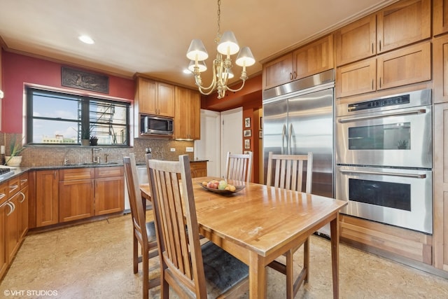 dining space featuring an inviting chandelier and sink