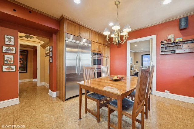 dining space with ornamental molding and a chandelier