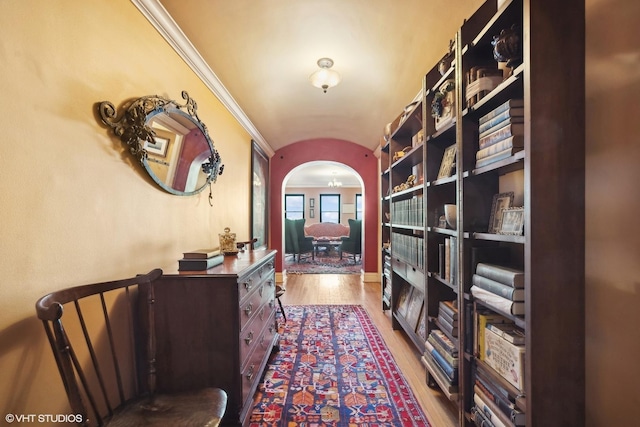 interior space with crown molding, vaulted ceiling, and hardwood / wood-style floors