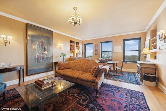 living room with ornamental molding, hardwood / wood-style floors, and a notable chandelier