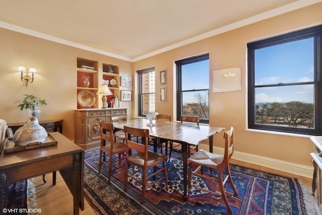 dining space featuring crown molding and wood-type flooring