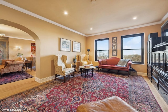 living room with crown molding and hardwood / wood-style floors