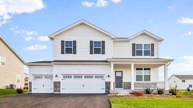 craftsman-style home with a front lawn, a porch, a garage, and cooling unit