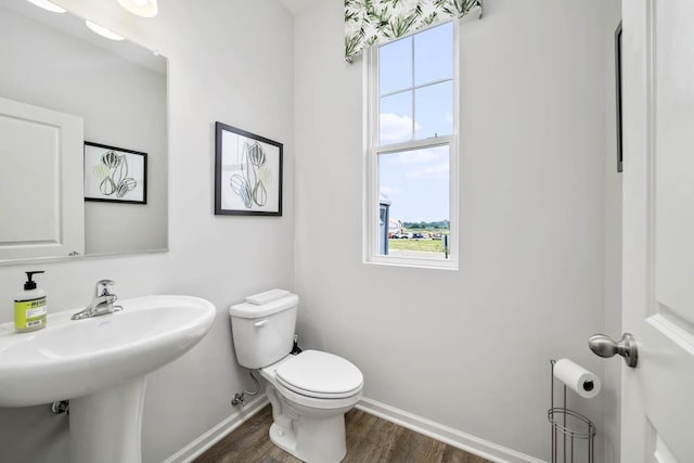 bathroom featuring hardwood / wood-style floors and toilet