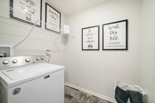 laundry area featuring washer / clothes dryer and dark tile patterned floors