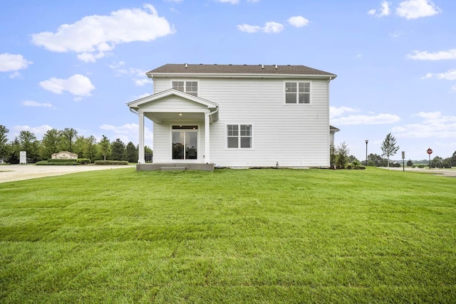 back of house with a lawn