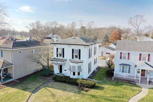 rear view of house featuring a lawn