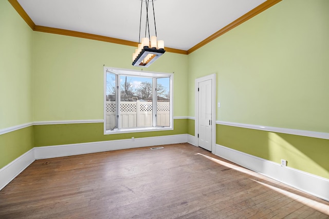 unfurnished dining area with hardwood / wood-style floors and crown molding