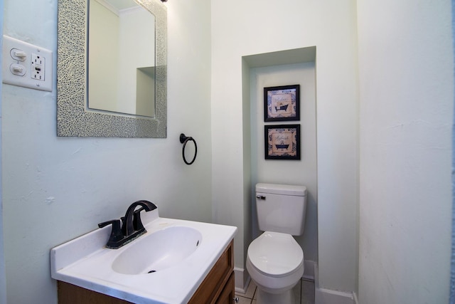 bathroom featuring vanity, toilet, and crown molding