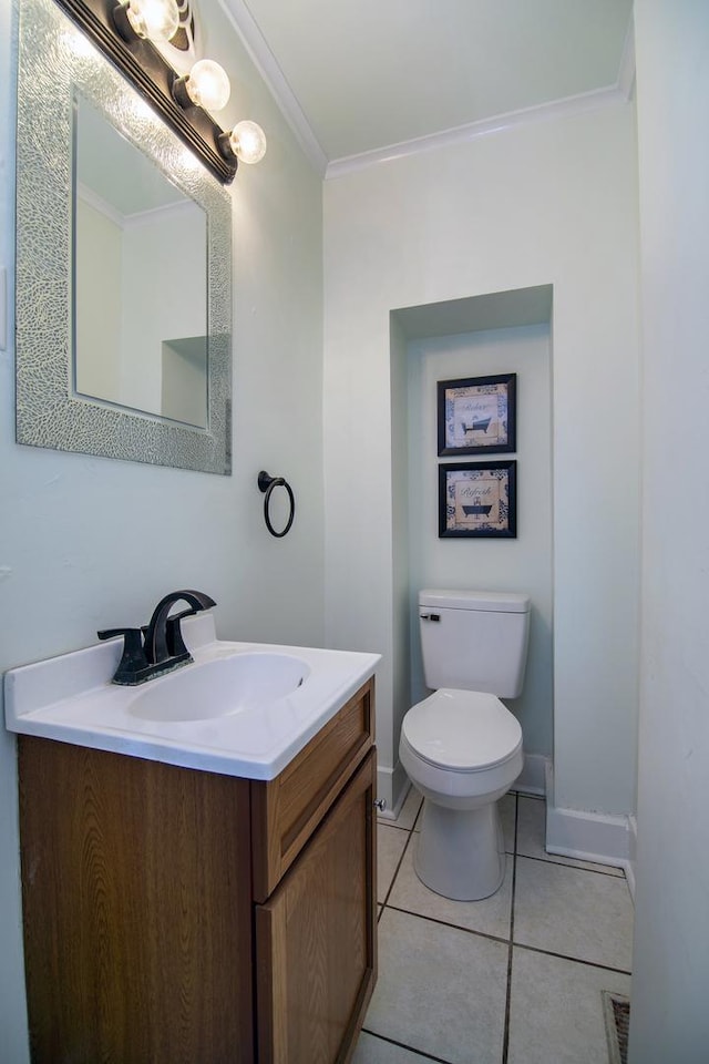 bathroom with toilet, tile patterned flooring, vanity, and ornamental molding