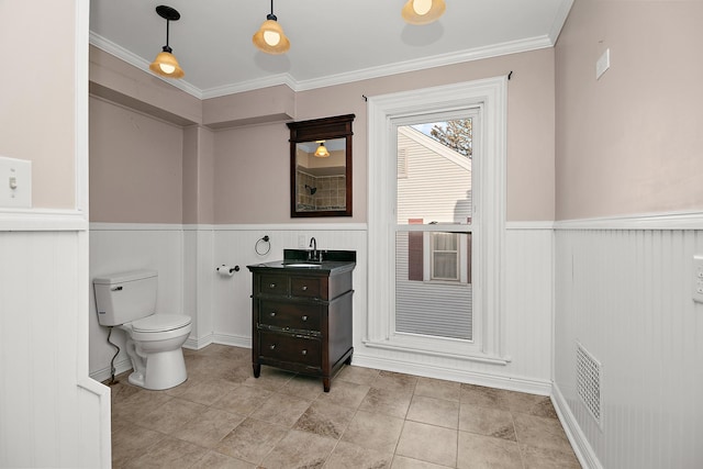 bathroom featuring crown molding, vanity, and toilet