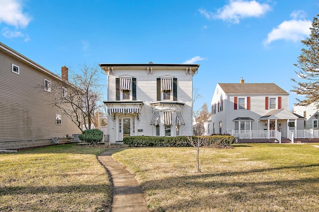 italianate-style house featuring central air condition unit and a front yard