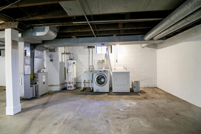 basement with independent washer and dryer, sink, heating unit, and water heater