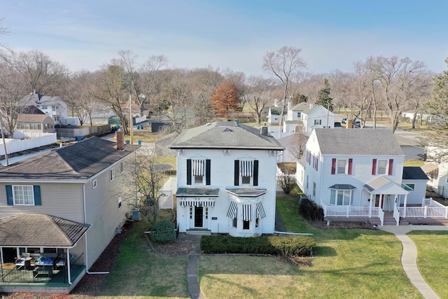 view of front of home with central air condition unit and a front lawn