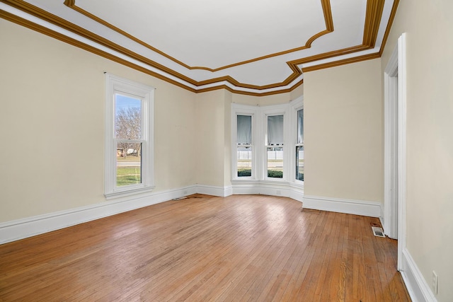 unfurnished room featuring crown molding and hardwood / wood-style floors