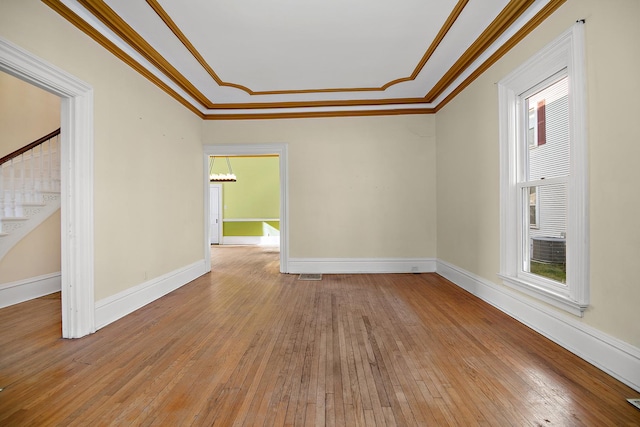 unfurnished room featuring wood-type flooring and ornamental molding