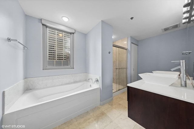 bathroom featuring vanity and shower with separate bathtub