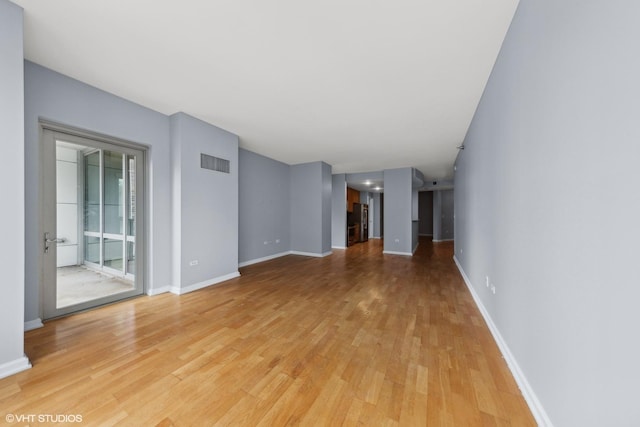 unfurnished living room with light hardwood / wood-style flooring