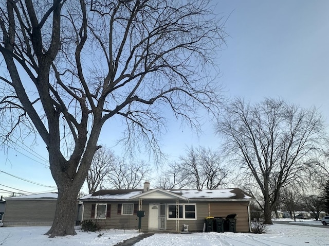 view of front of house featuring a chimney